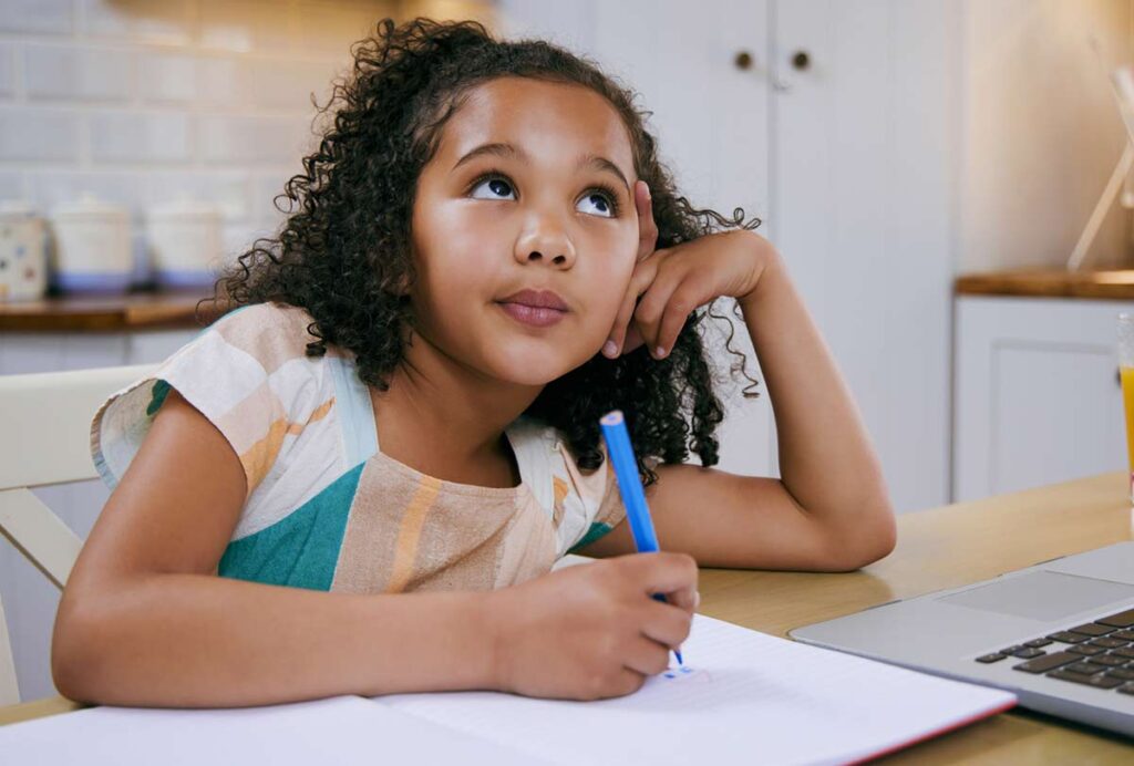 Girl at kitchen table daydreaming
